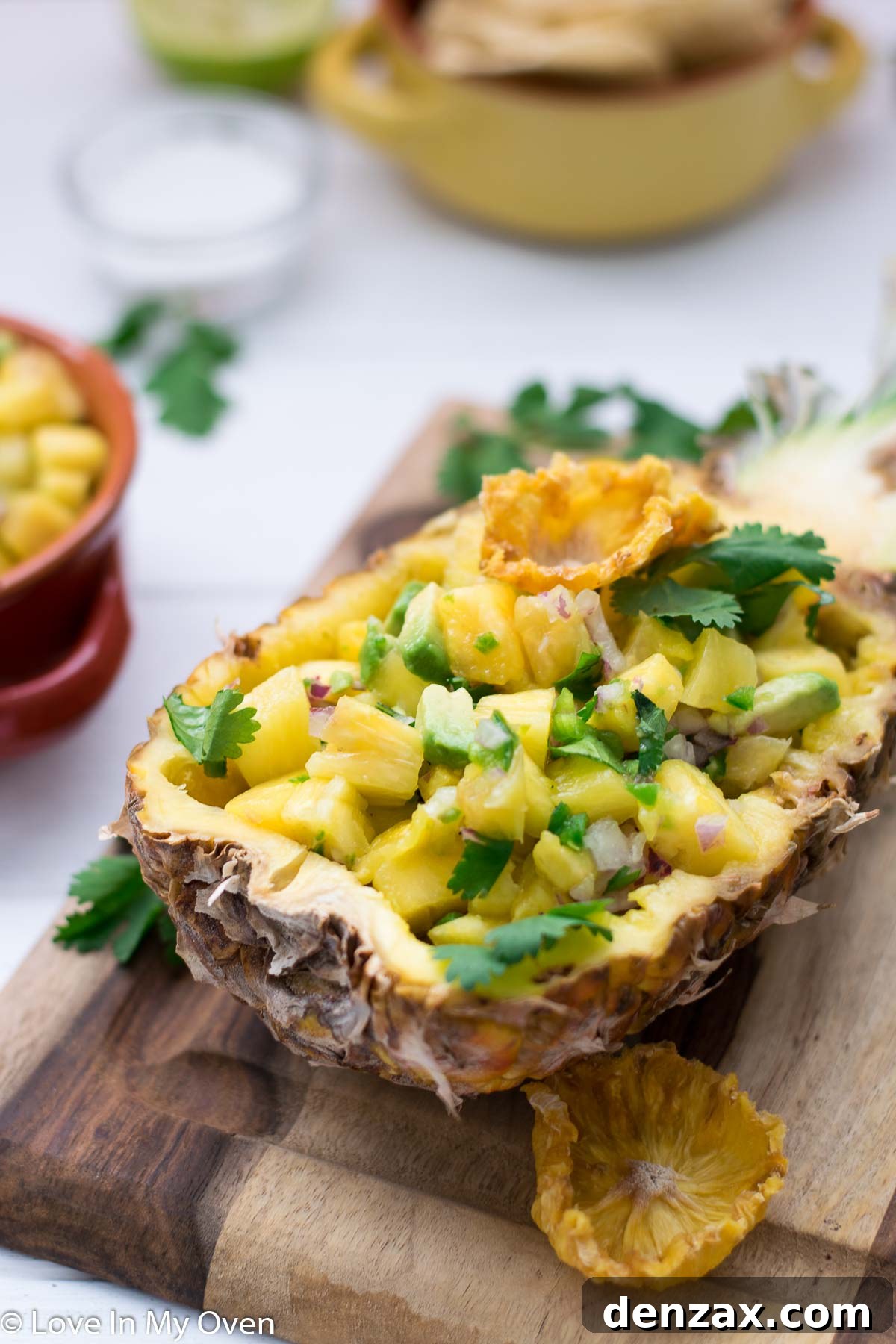 Serving bowl of pineapple avocado salsa with tortilla chips