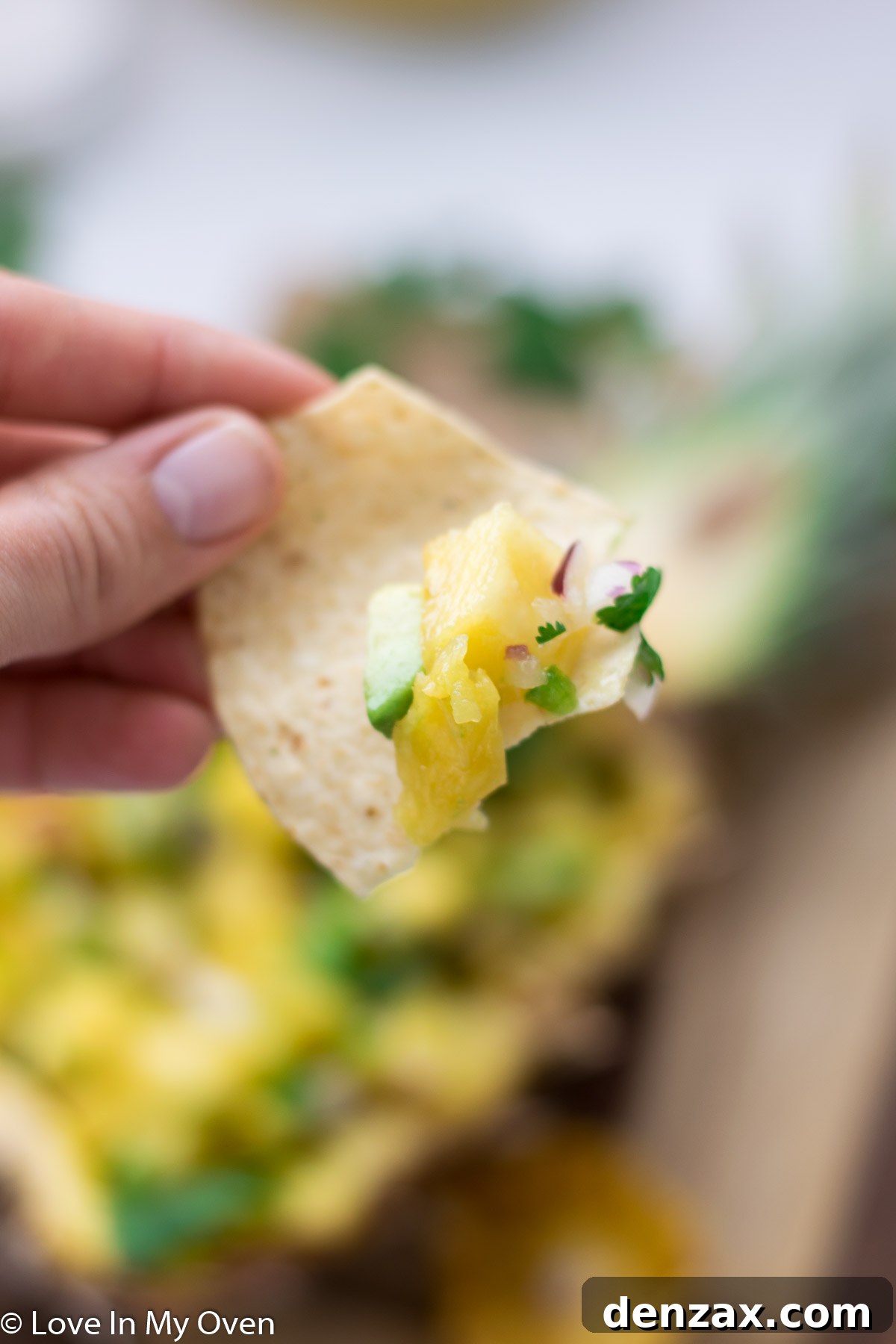 Top-down view of pineapple avocado salsa in a white bowl