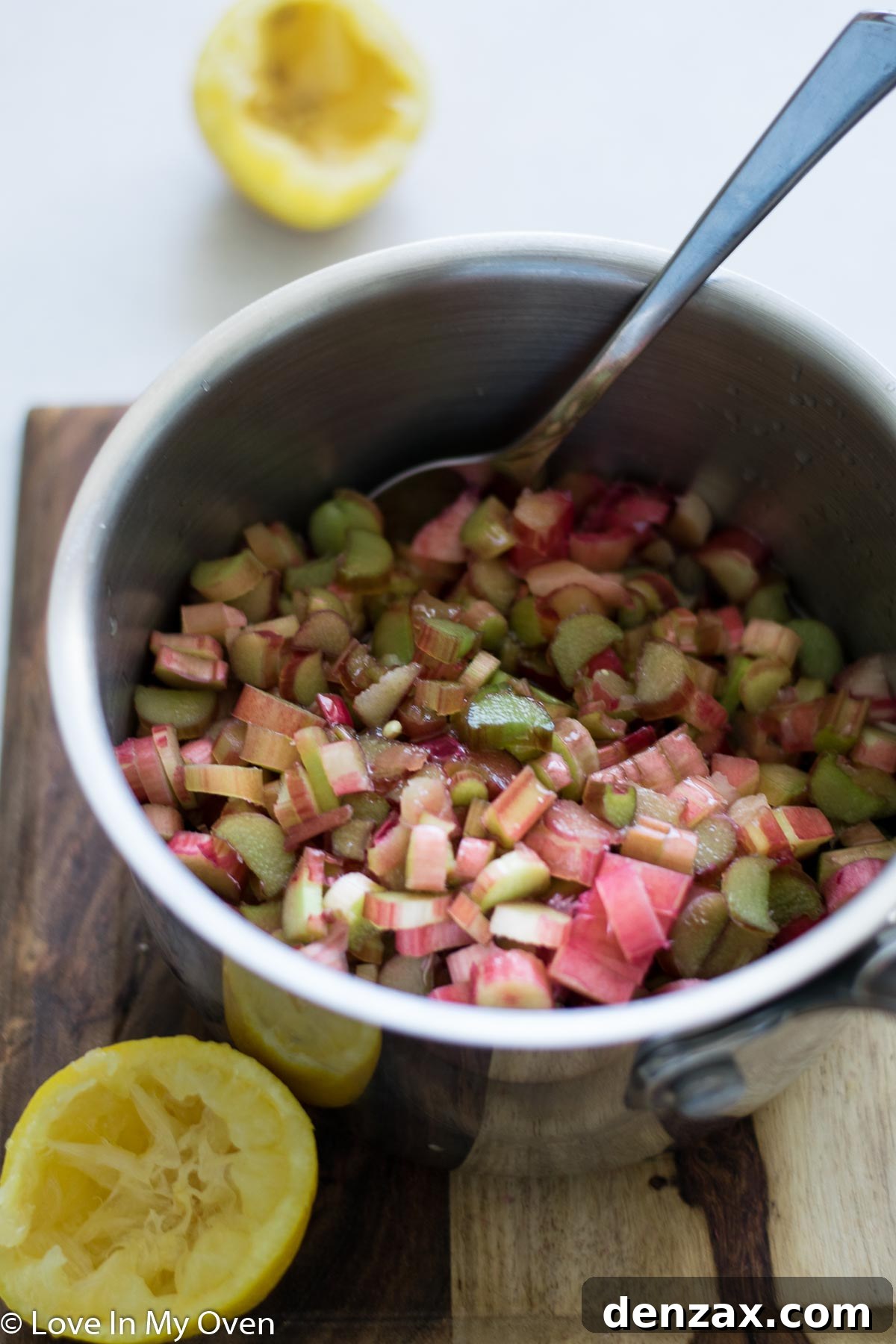 Rhubarb mixture simmering in a pot on the stove.