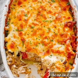 top view of chicken fajita casserole in an oval baking dish topped with melted cheese