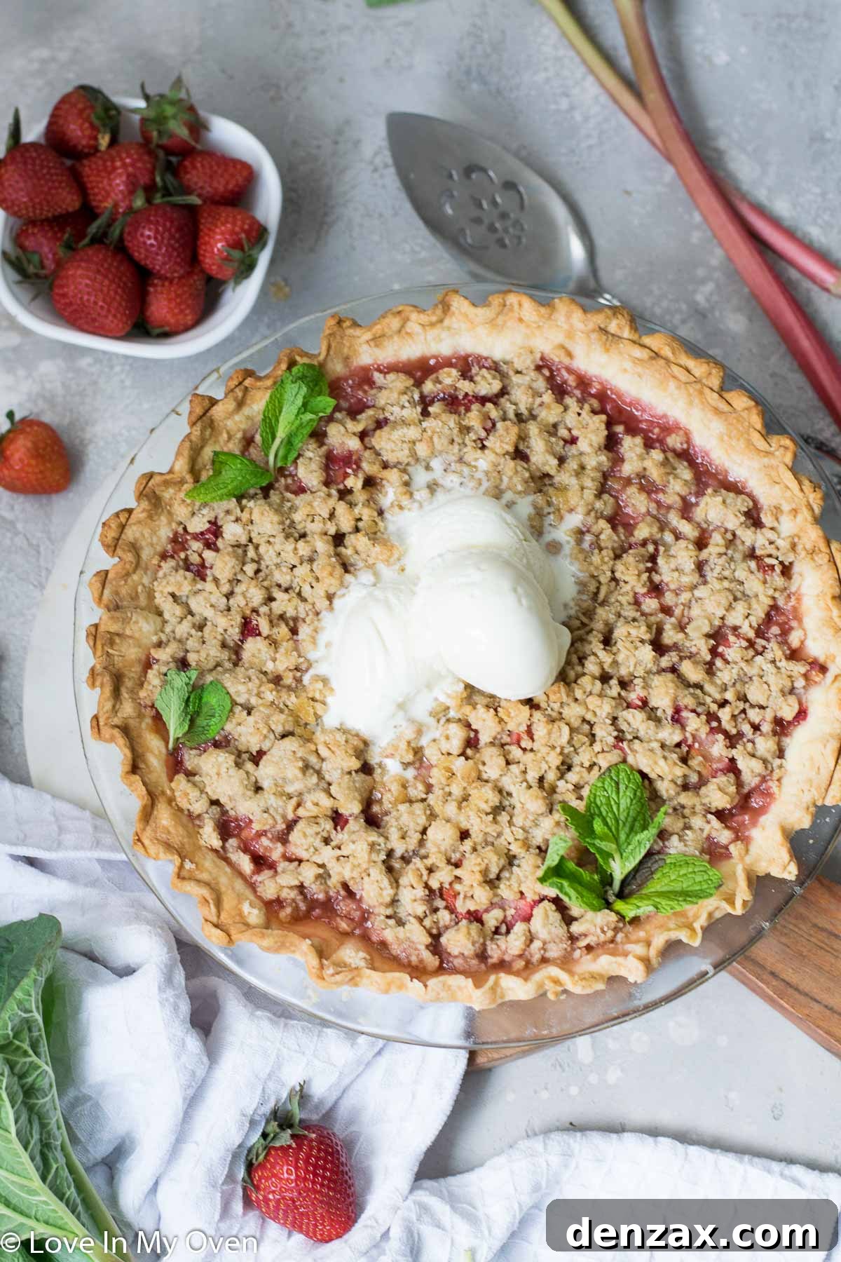 Close-up of baked Strawberry Rhubarb Crumble Pie, showcasing its golden crust and bubbly filling