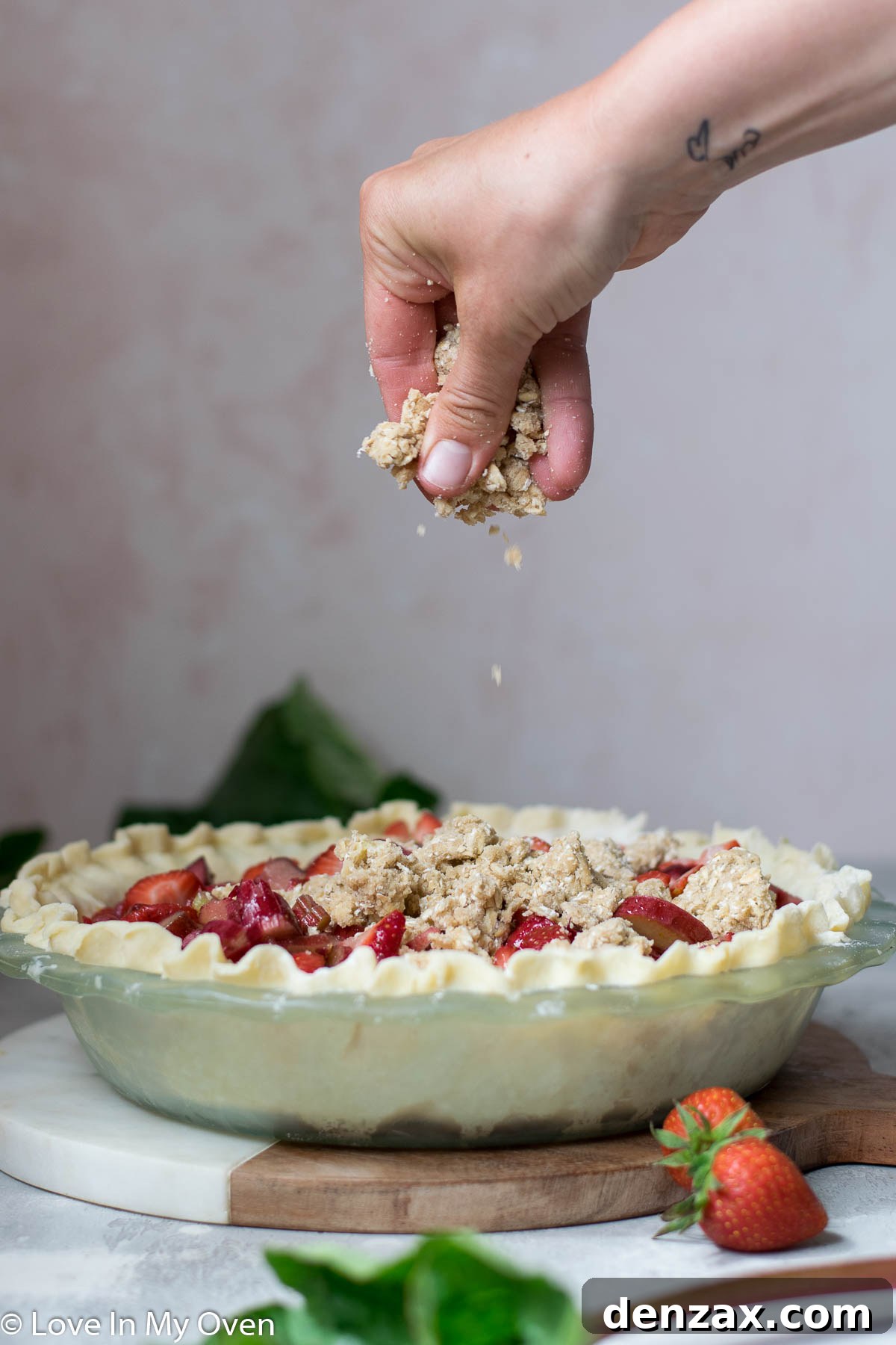 Unbaked strawberry rhubarb crumble pie with streusel topping
