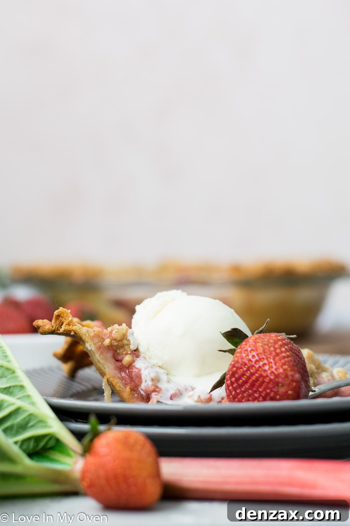 Overhead view of a whole strawberry rhubarb crumble pie, ready to be served