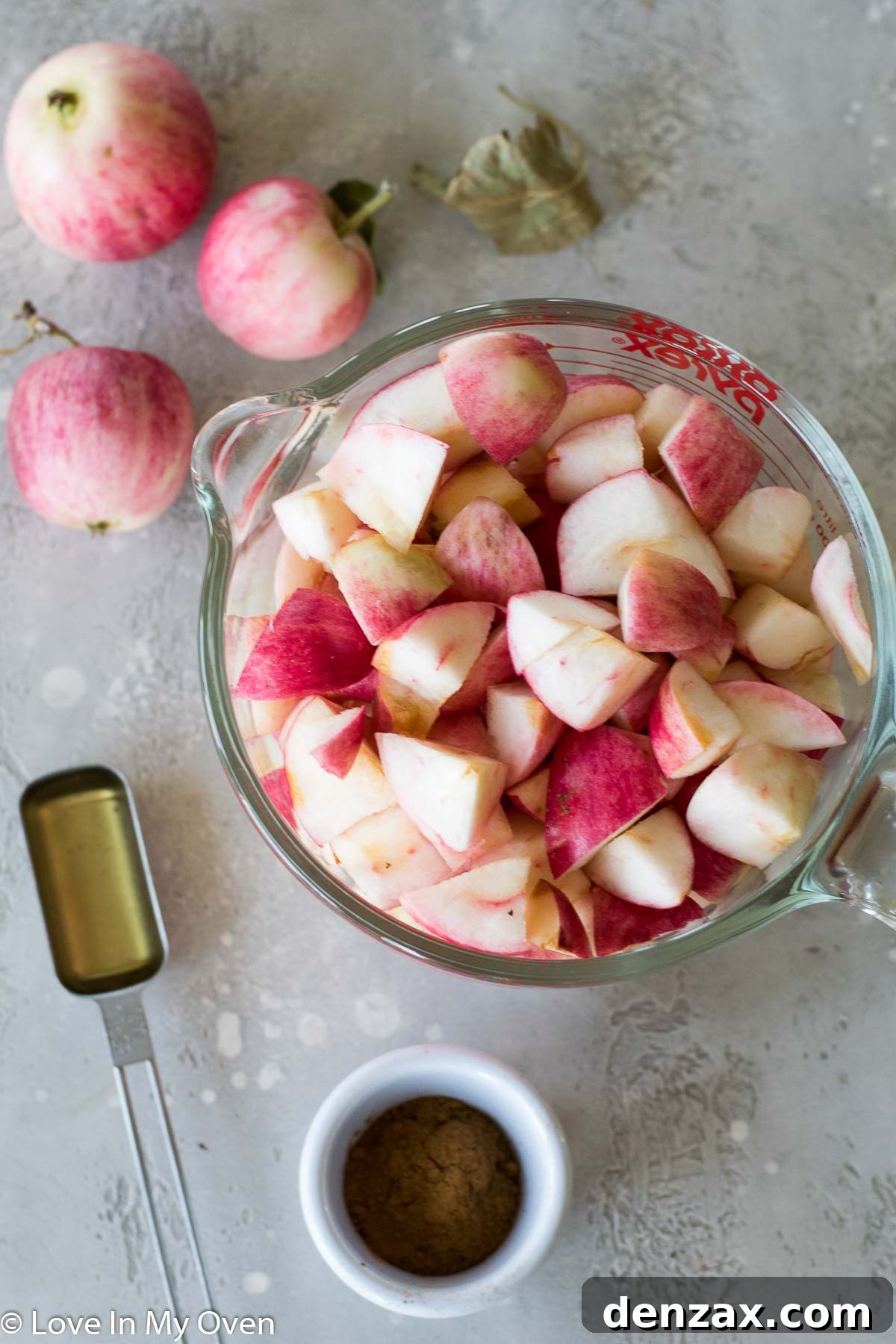 Close-up of fresh apples, honey, and cinnamon sticks – ingredients for apple fruit leather
