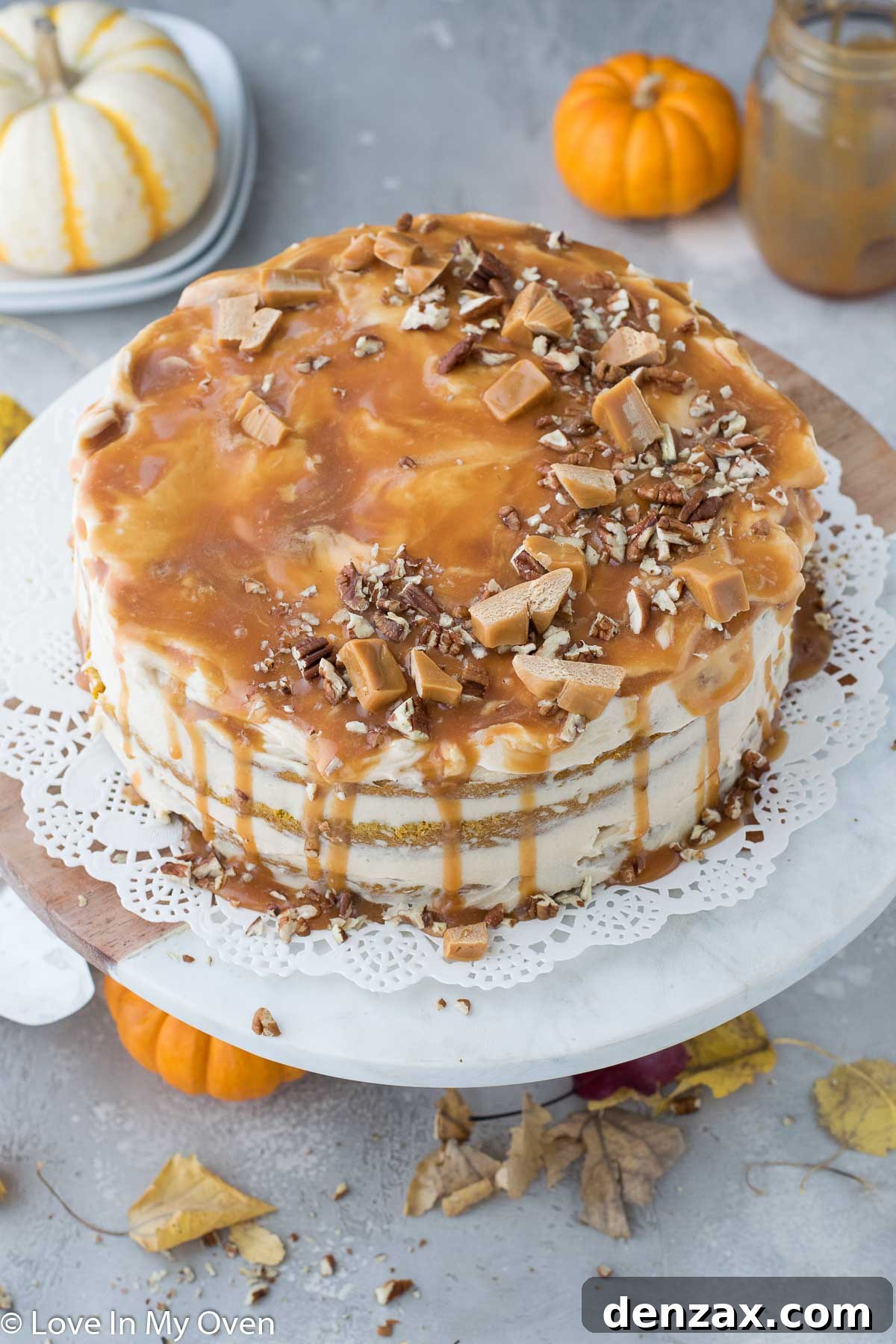 Close-up of a slice of Pumpkin Caramel Cake showing moist layers and creamy frosting.
