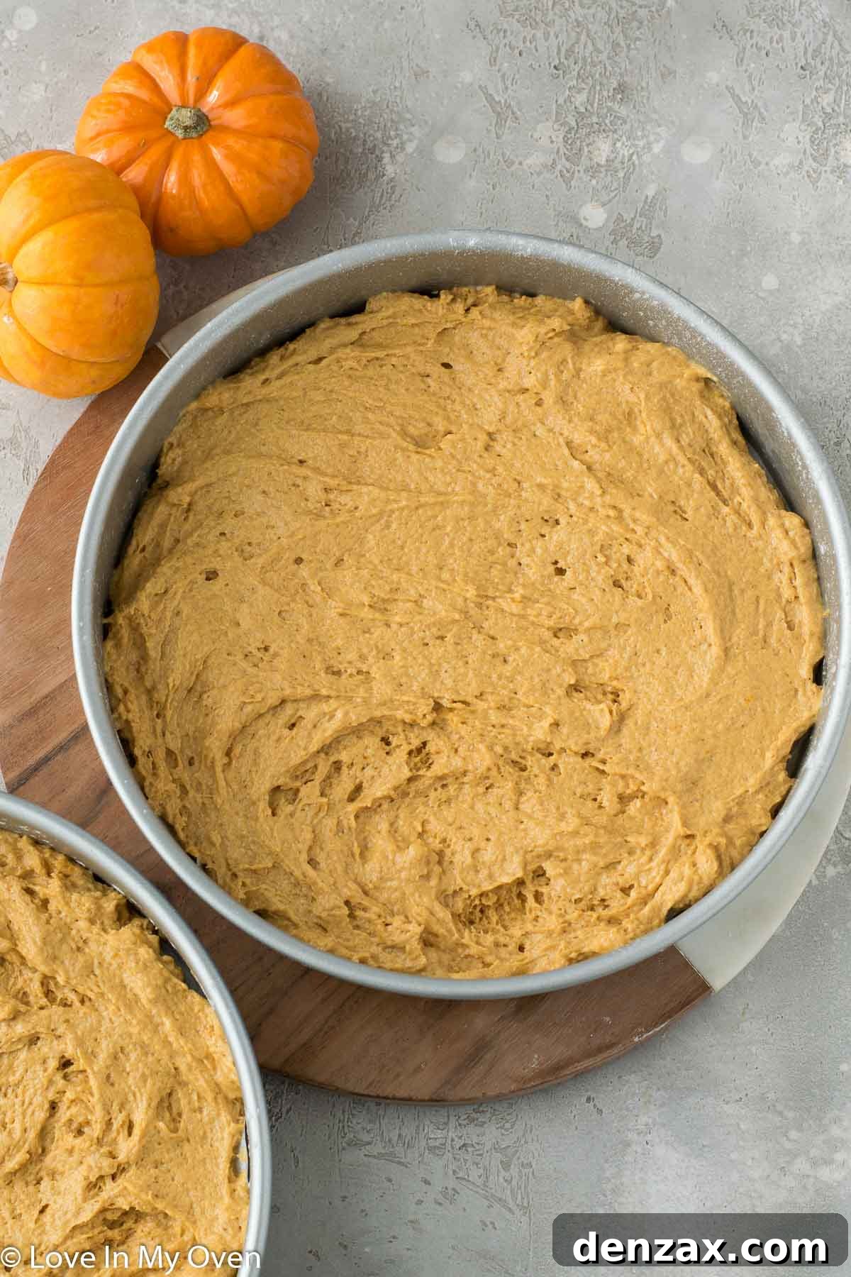 Pumpkin cake batter poured into baking pans, ready for the oven.