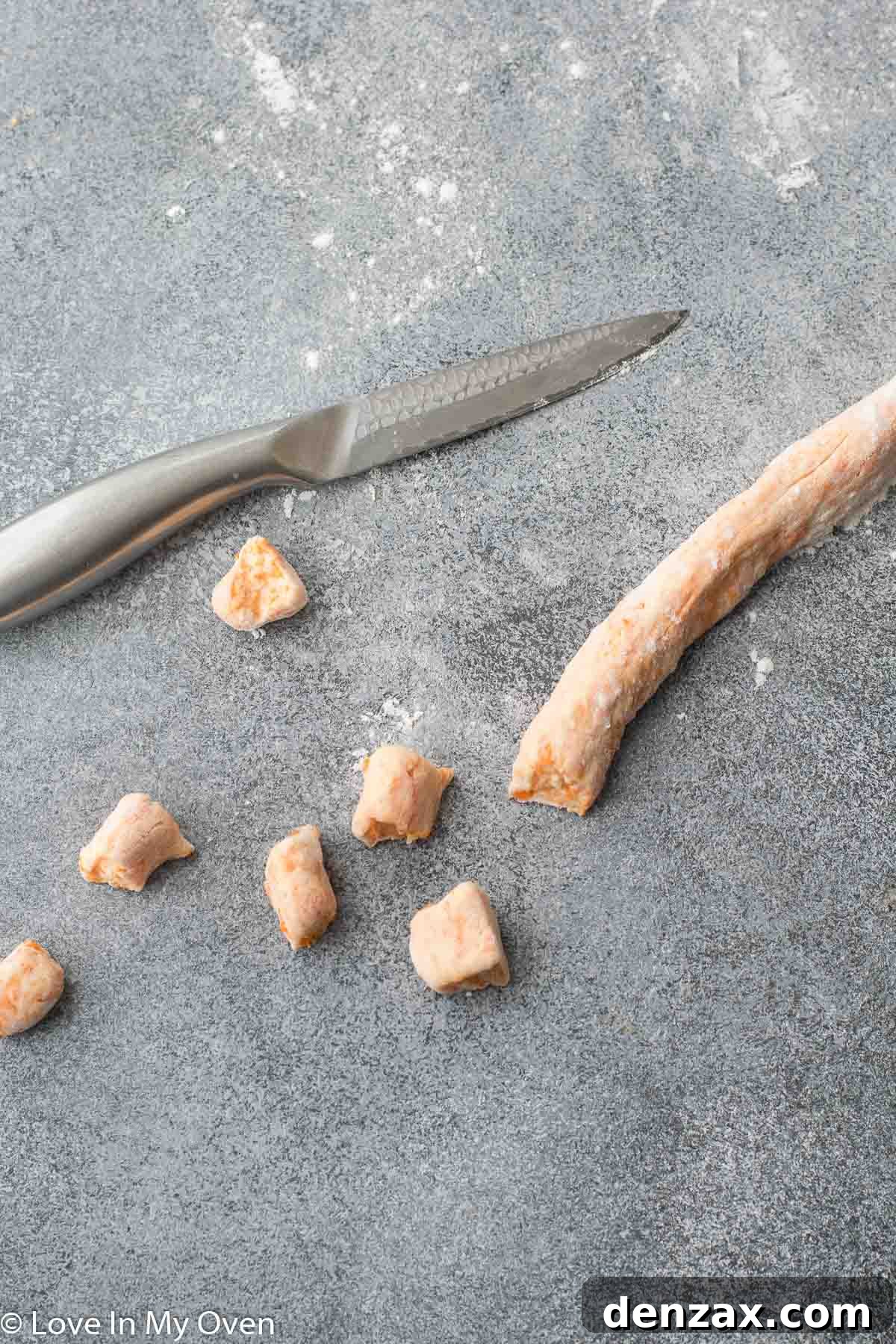 Gnocchi ropes being cut into individual pieces