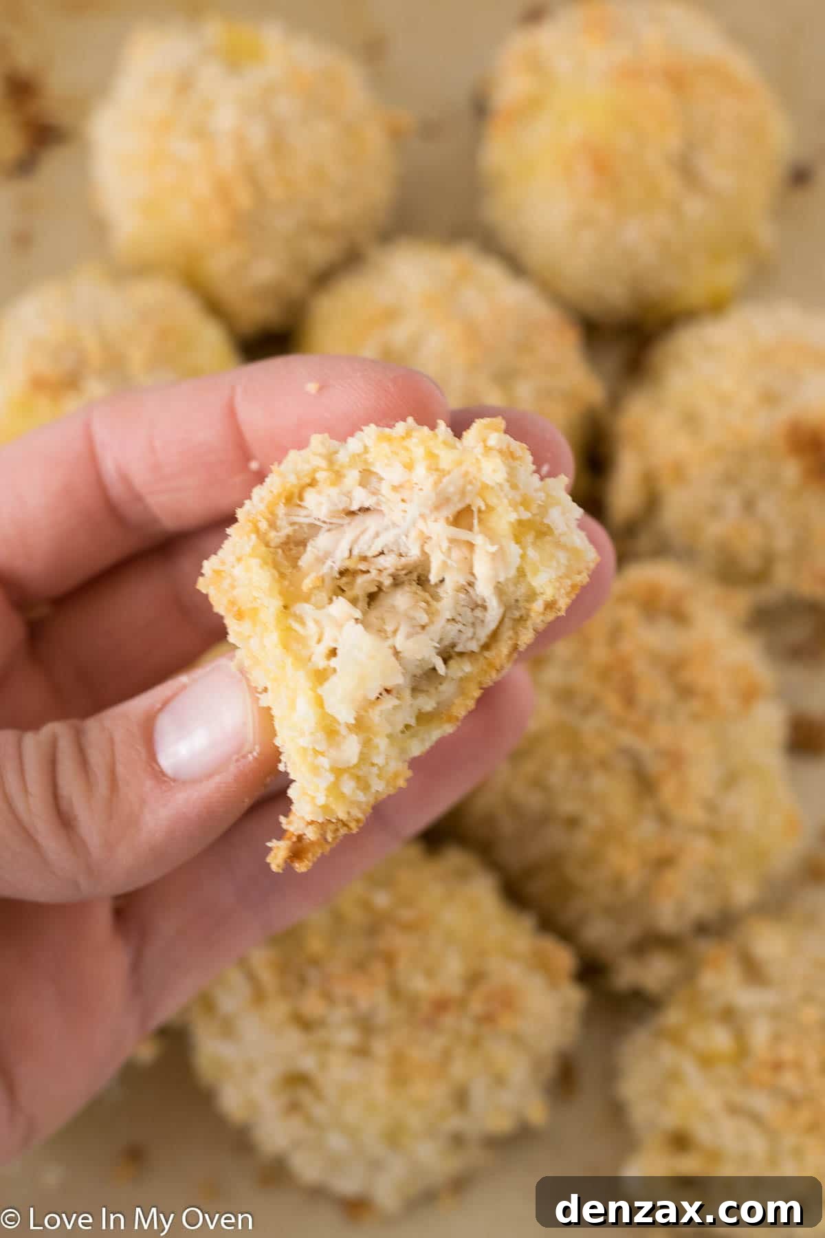 Hand placing turkey cheese balls on the charcuterie wreath