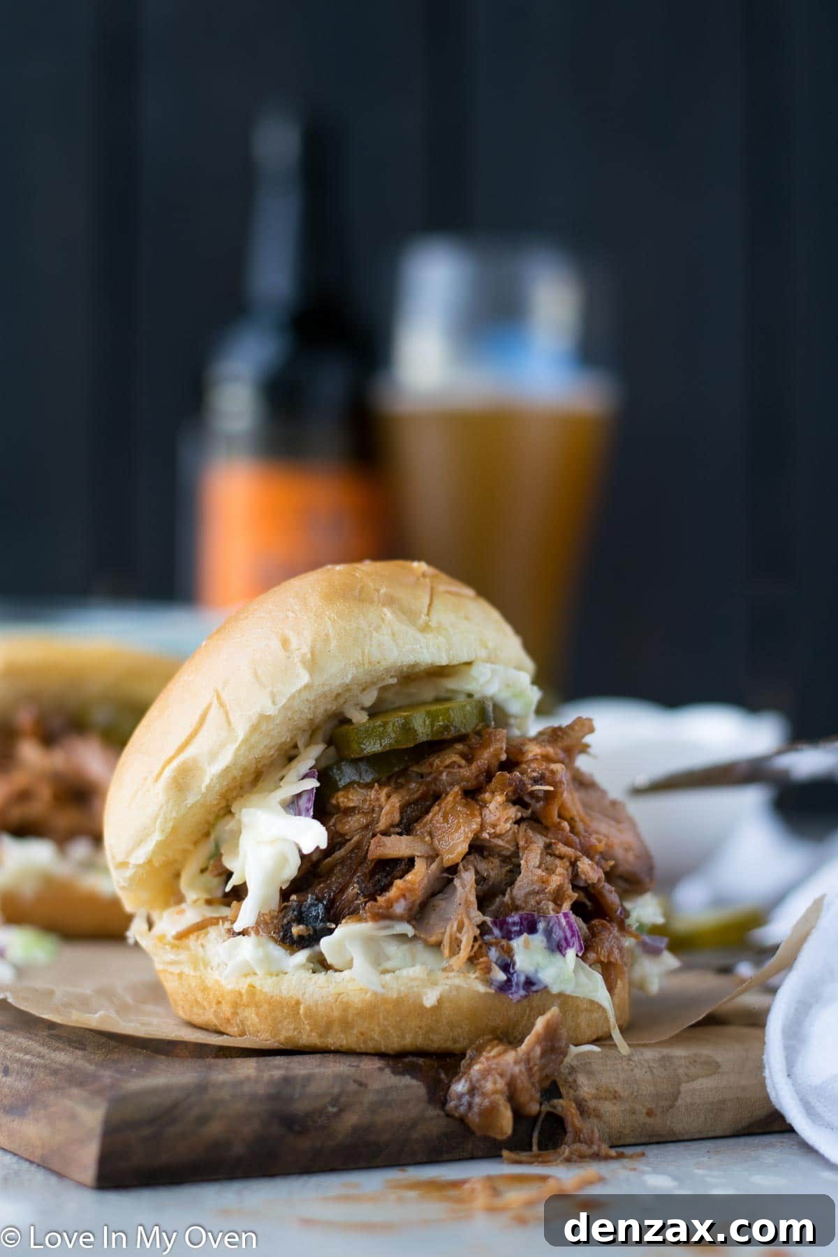 Close-up of shredded apple cider pulled pork on a plate, ready to be served.