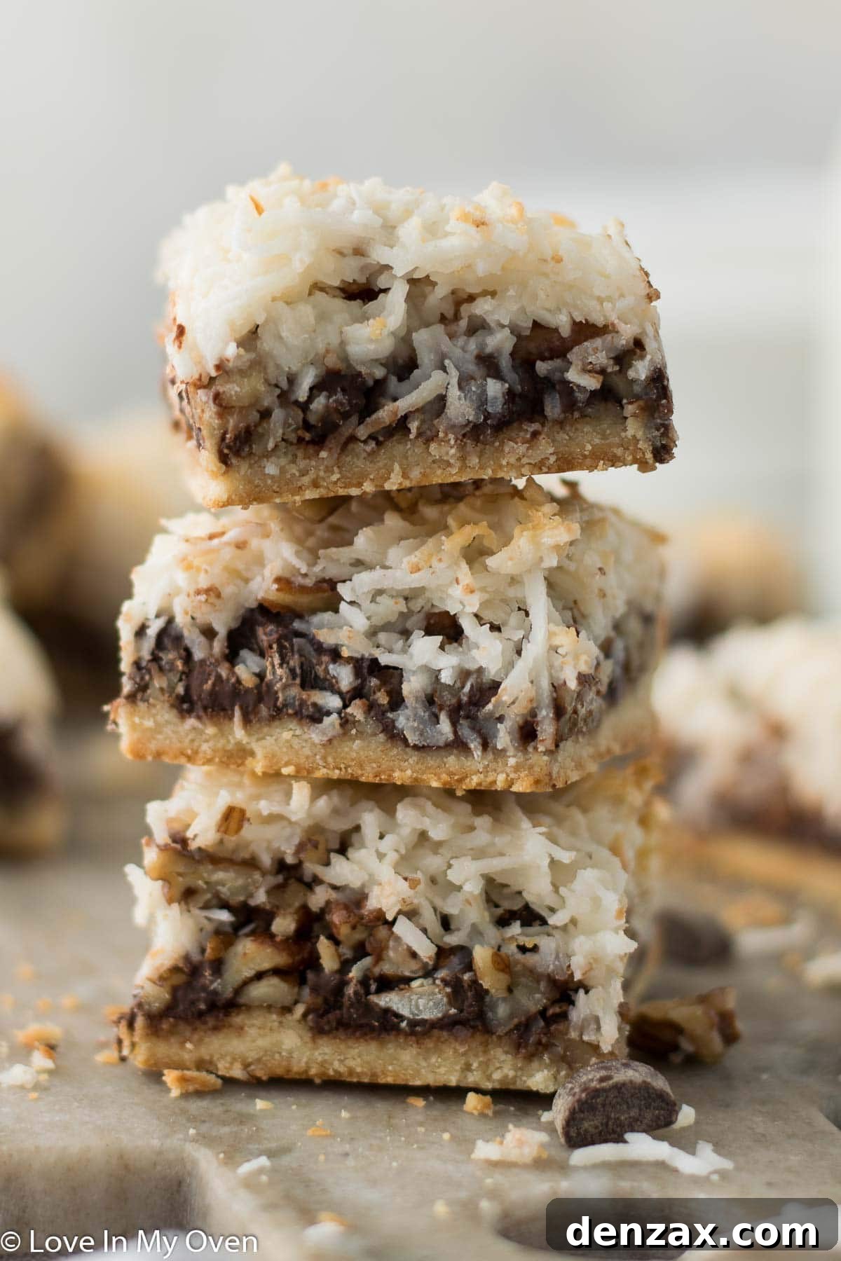 Several vegan magic bars arranged on a white plate, showcasing their perfect squares and delicious appearance.