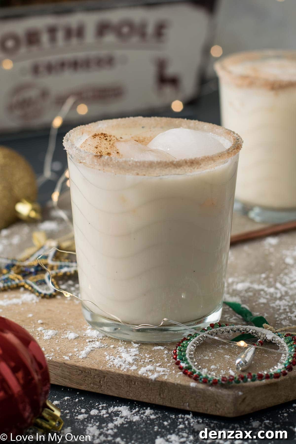 Overhead shot of a Vodka Eggnog Cocktail with Christmas lights and ornaments
