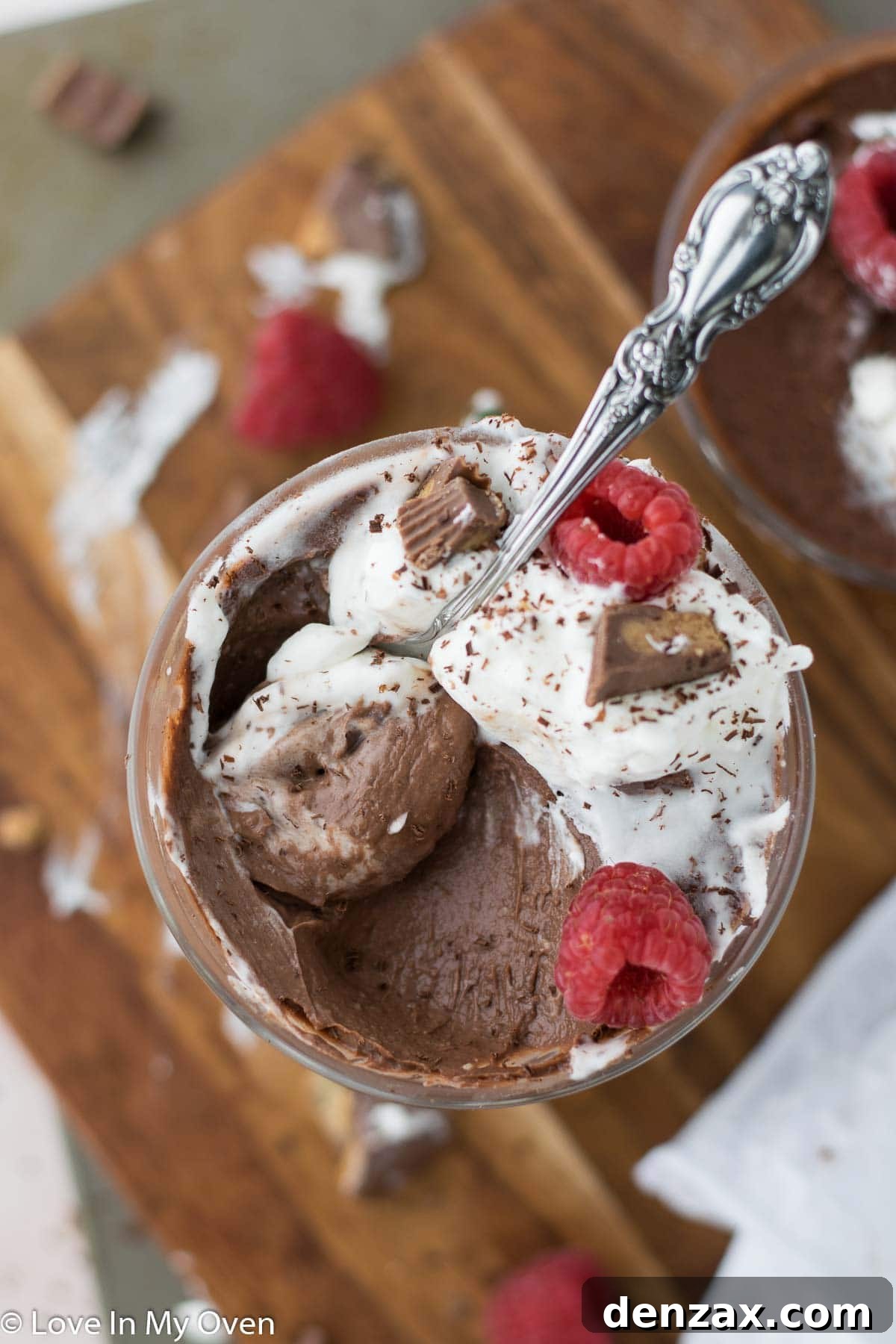 Decadent vegan chocolate peanut butter pudding served in clear glass dishes, topped with chocolate shavings.