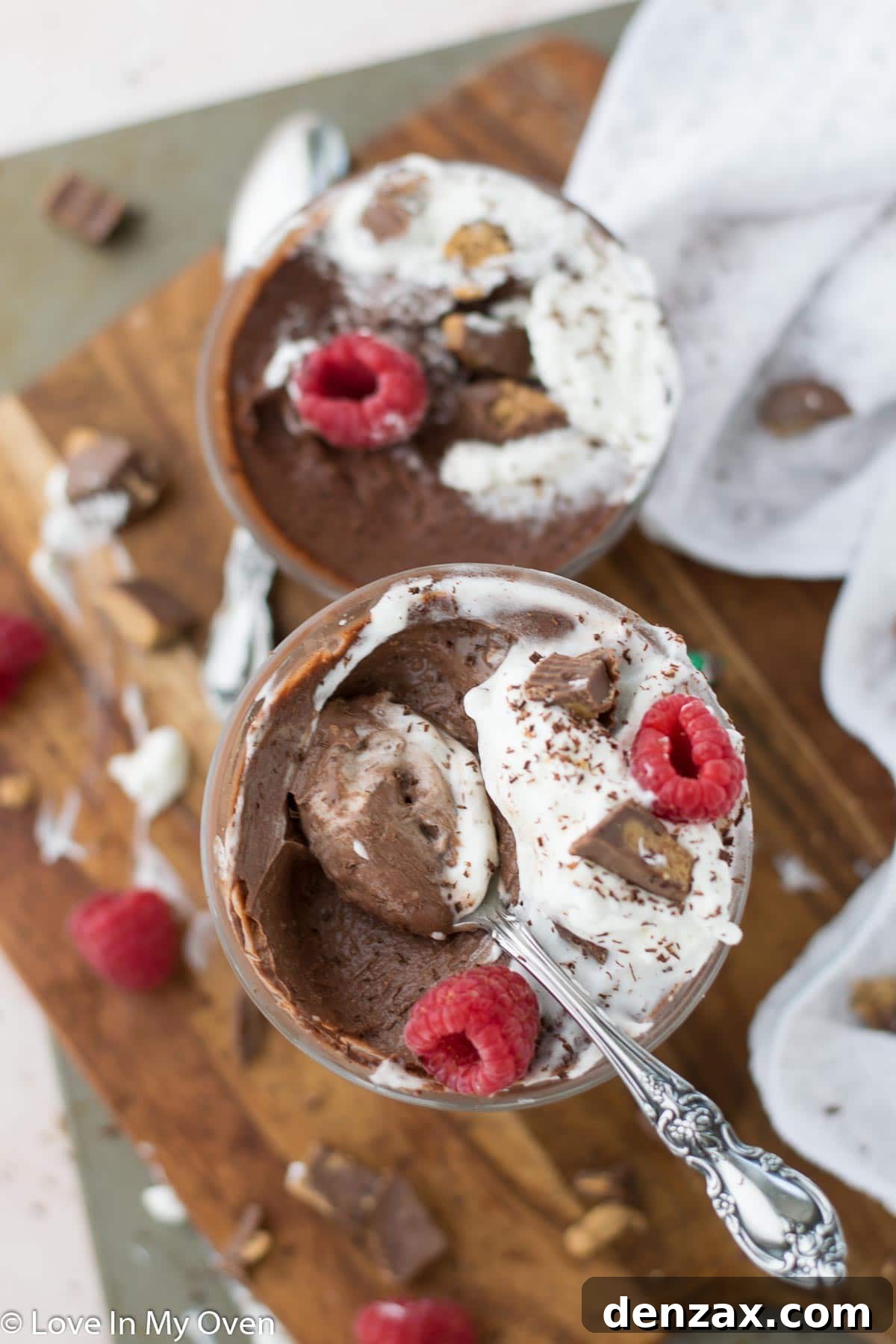 Close-up of creamy vegan chocolate peanut butter pudding with a spoon, highlighting its smooth texture.