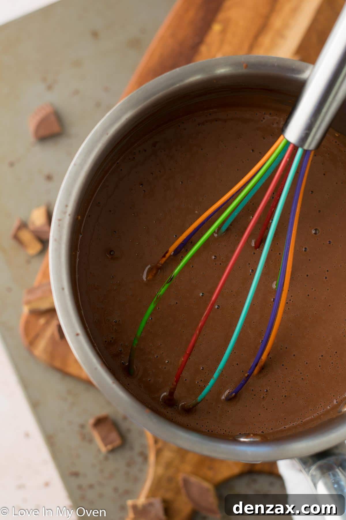 Four servings of vegan chocolate peanut butter pudding chilling in glass dishes in a refrigerator.