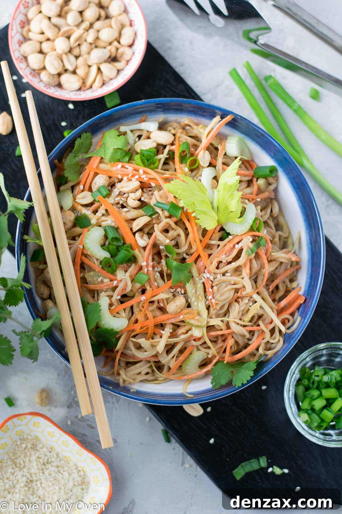 Sesame Peanut Noodle Salad with garnishes, ready to serve