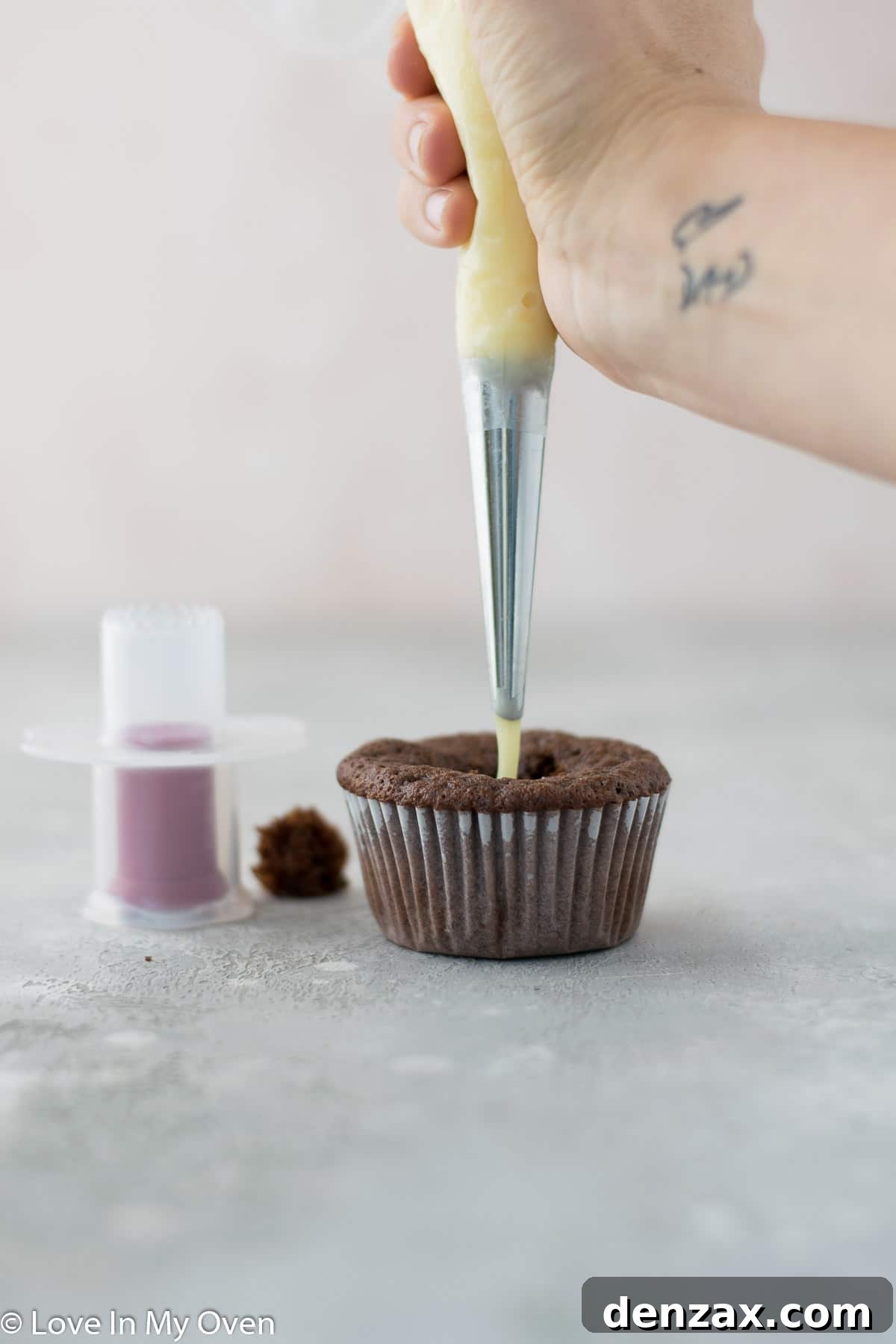 Filling cupcake with ganache