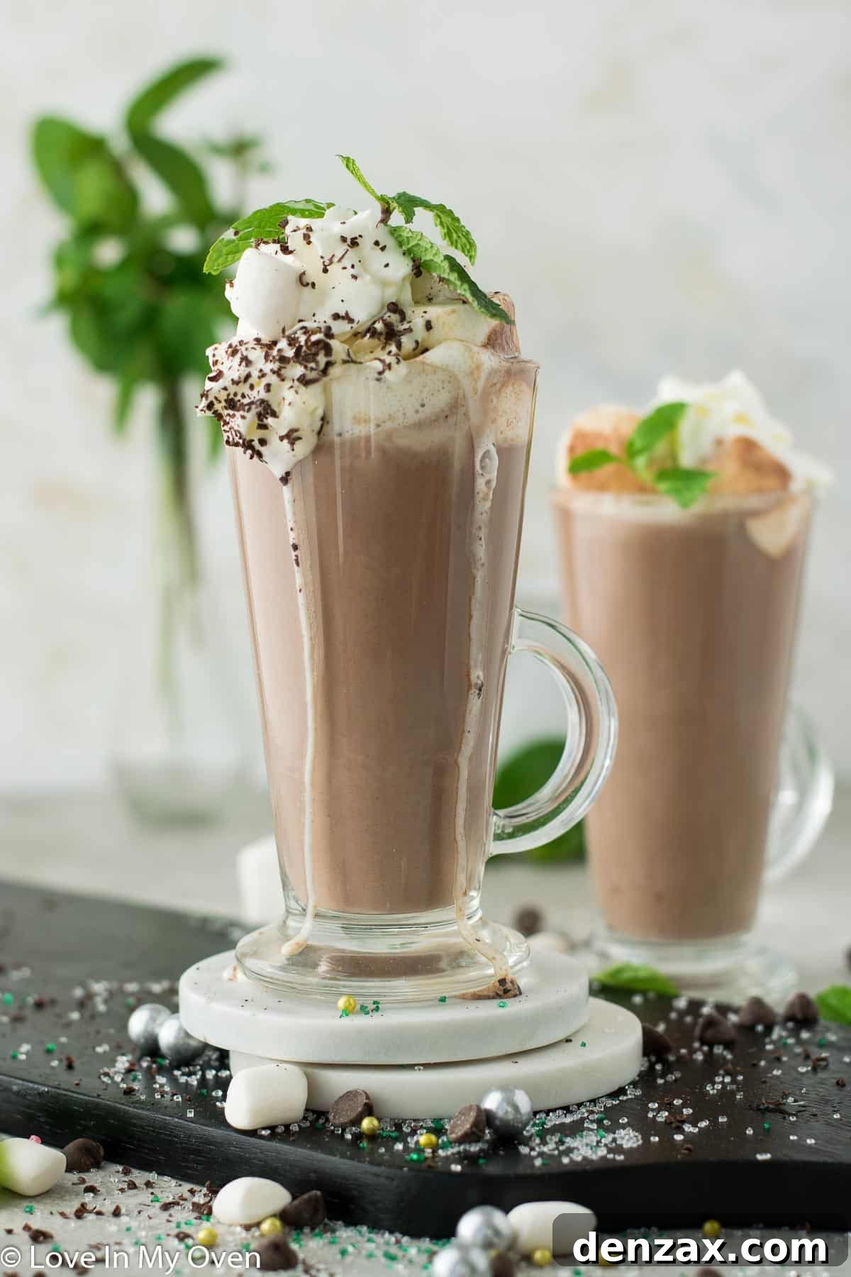 Delicious mint hot chocolate topped with whipped cream and chocolate shavings, perfect for a cold winter day.