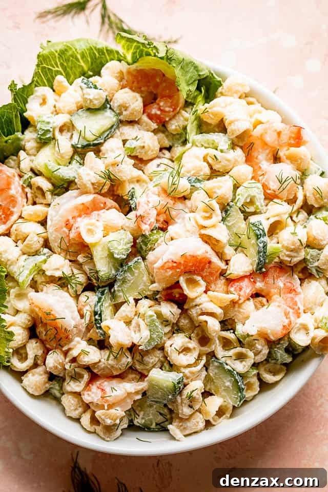 Top view of a generously portioned Creamy Shrimp Pasta Salad in a pristine white salad bowl, ready to be served
