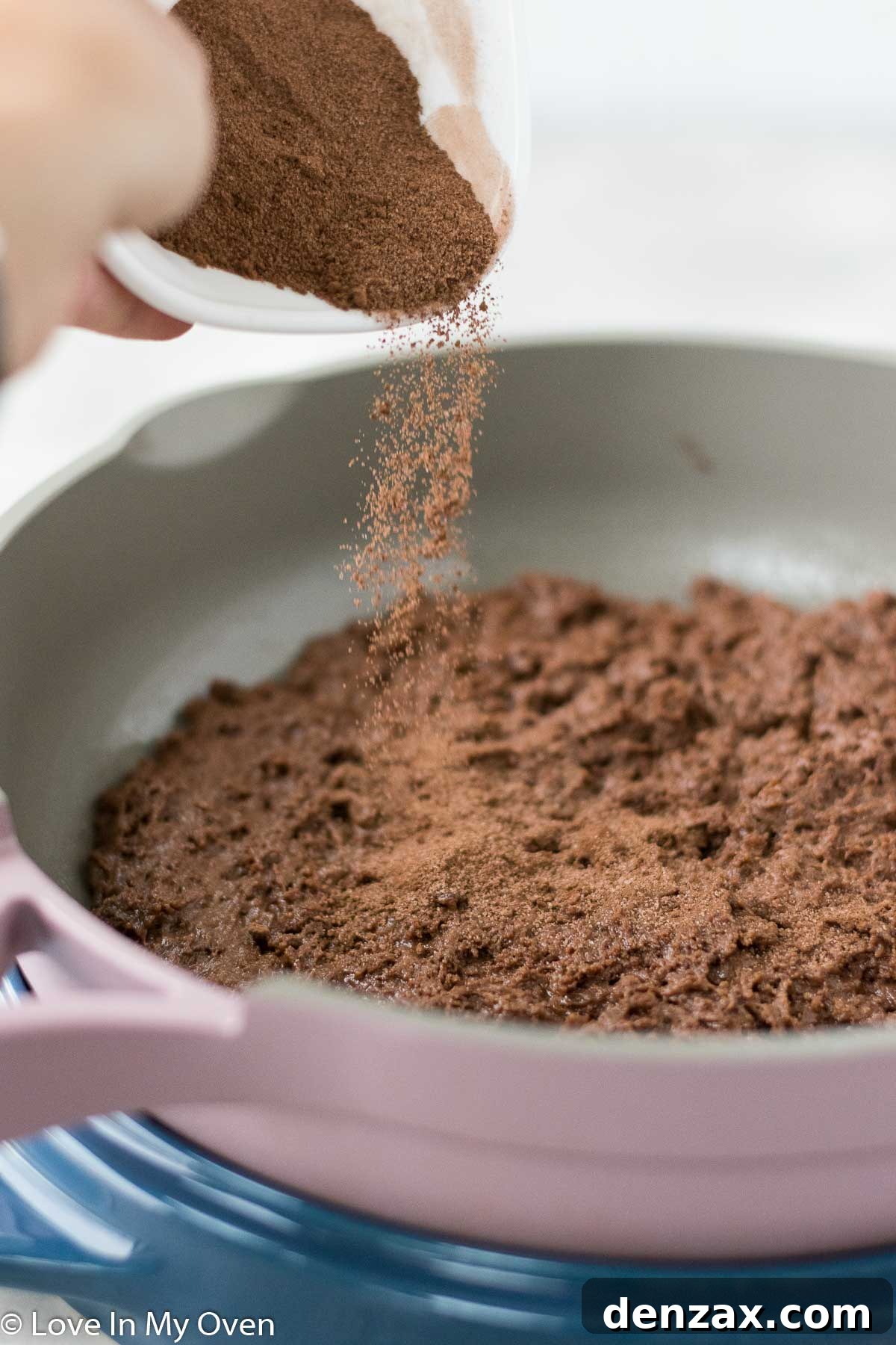 Spreading chocolate cake batter in a pan