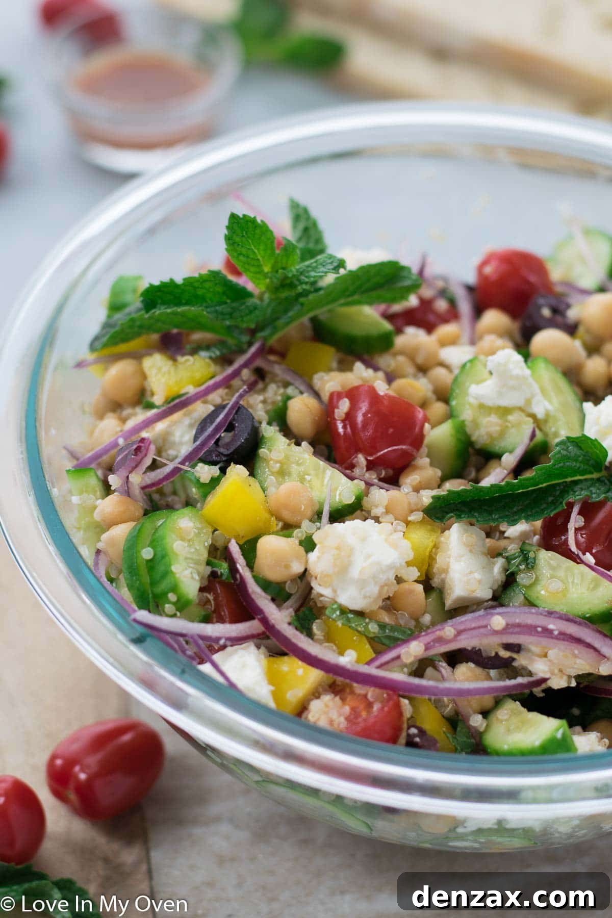 Overhead shot of Greek Chickpea Salad in a large bowl, garnished with fresh mint.