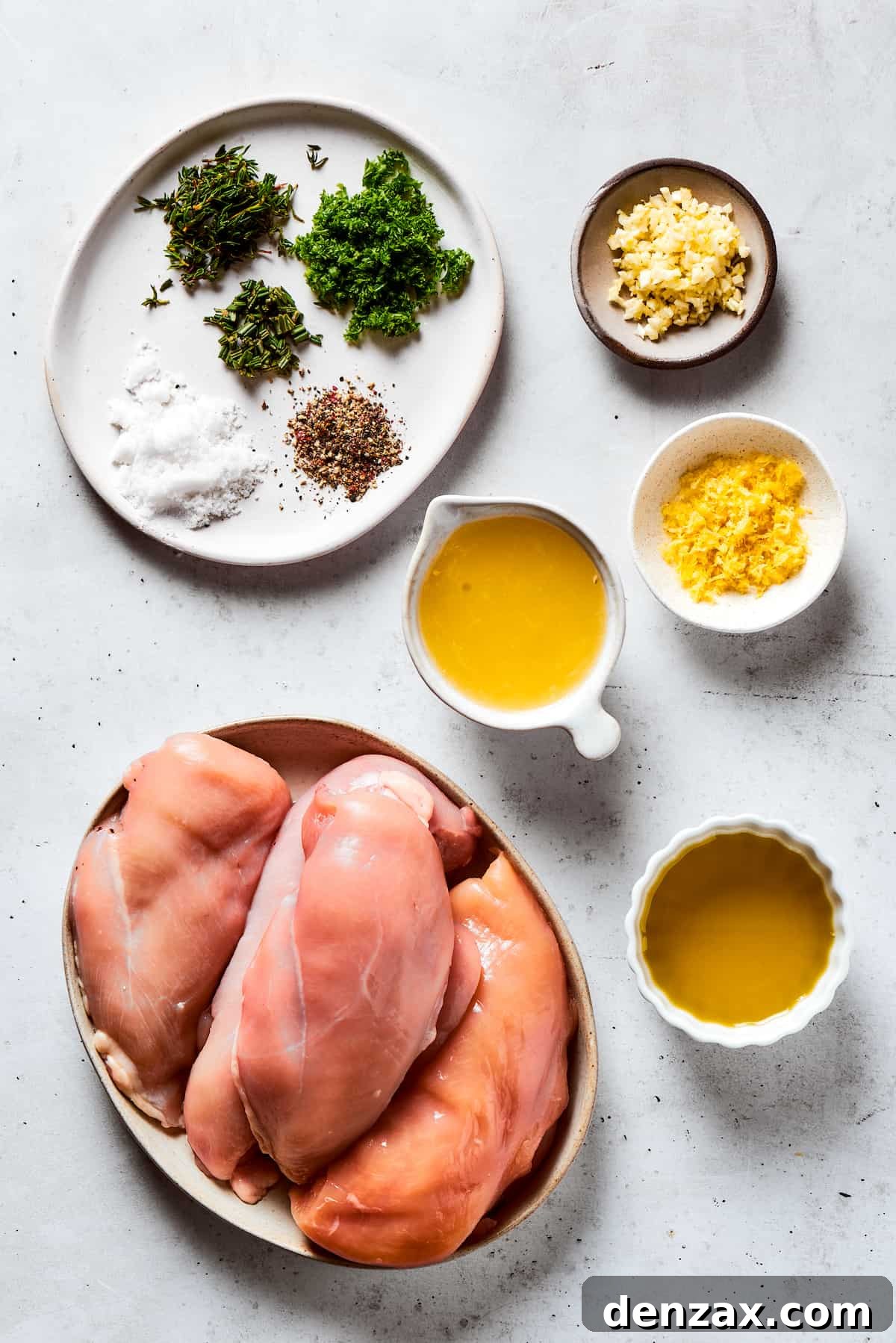 Overhead shot displaying the fresh ingredients for lemon chicken marinade: seasonings, minced garlic, vibrant lemon juice, raw chicken breasts, and golden olive oil.
