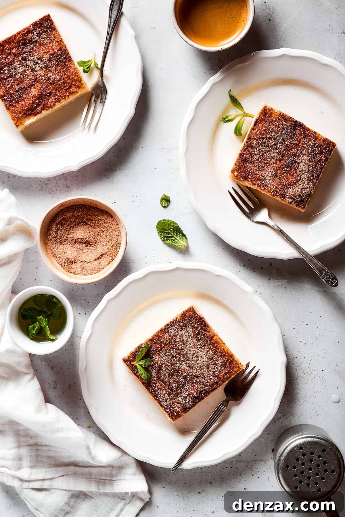 Squares of sopapilla cheesecake on dessert plates.