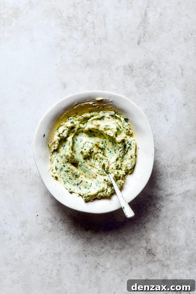 A dish of freshly mixed garlic herb butter ready to be formed into a log.