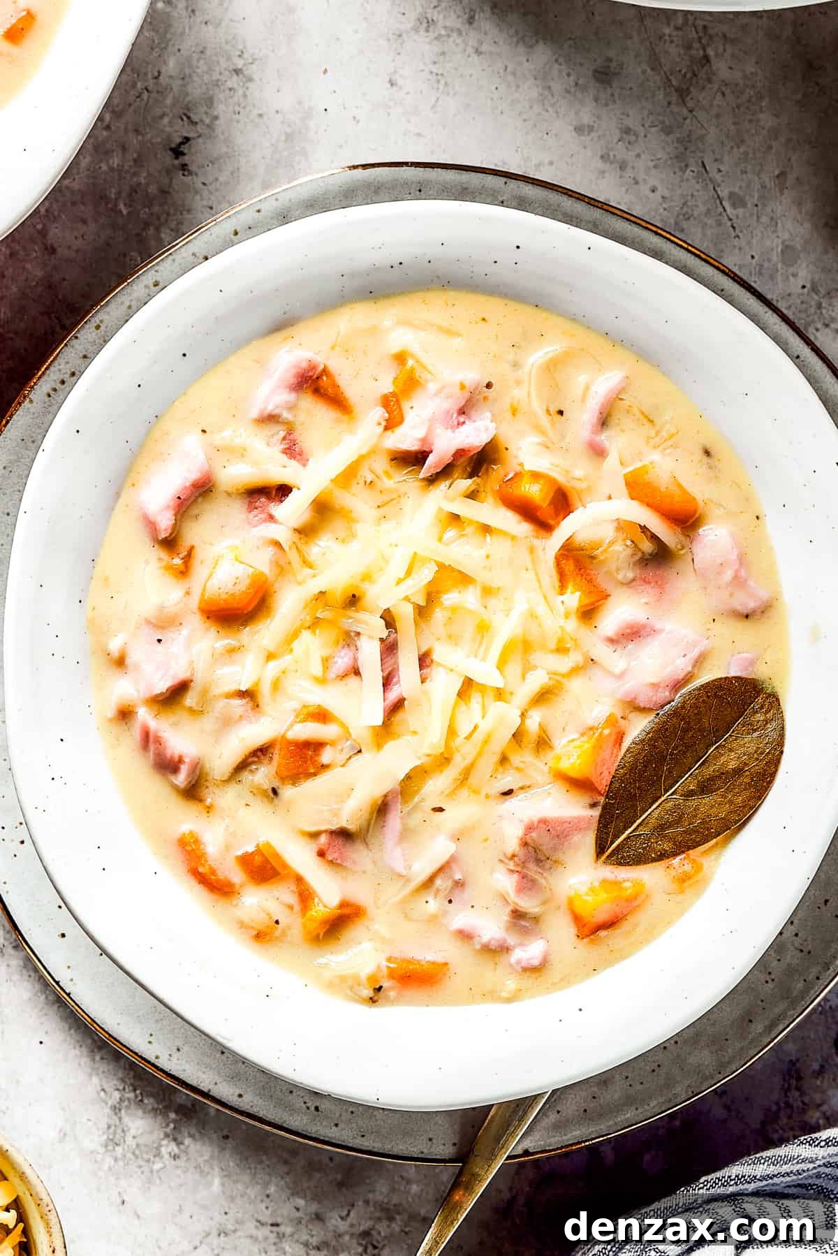 A bowl of creamy Reuben soup, garnished with a bay leaf, ready to be enjoyed.