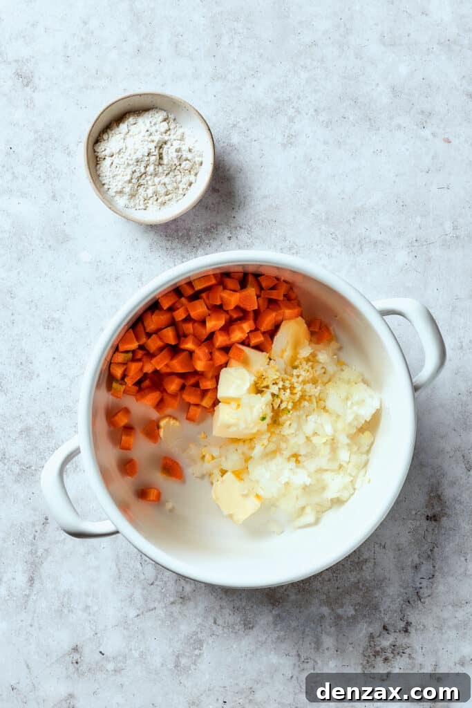 Cooking onions, garlic, and carrots with butter in a Dutch oven until softened.