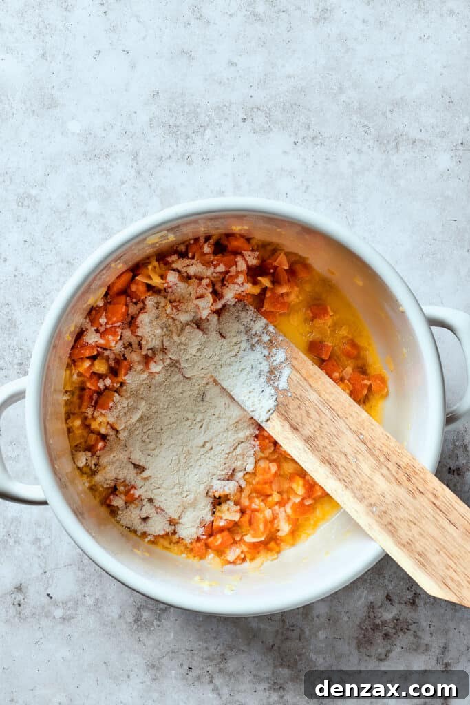Sprinkling flour over cooked vegetables in a Dutch oven to create a roux.
