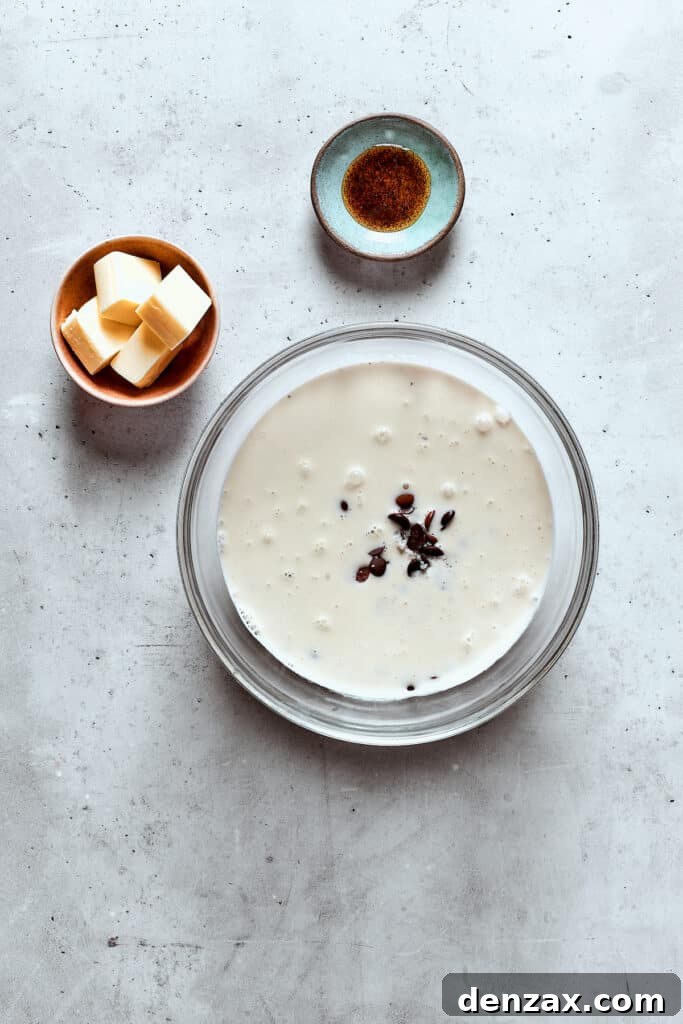 A bowl of chopped chocolate and cream.