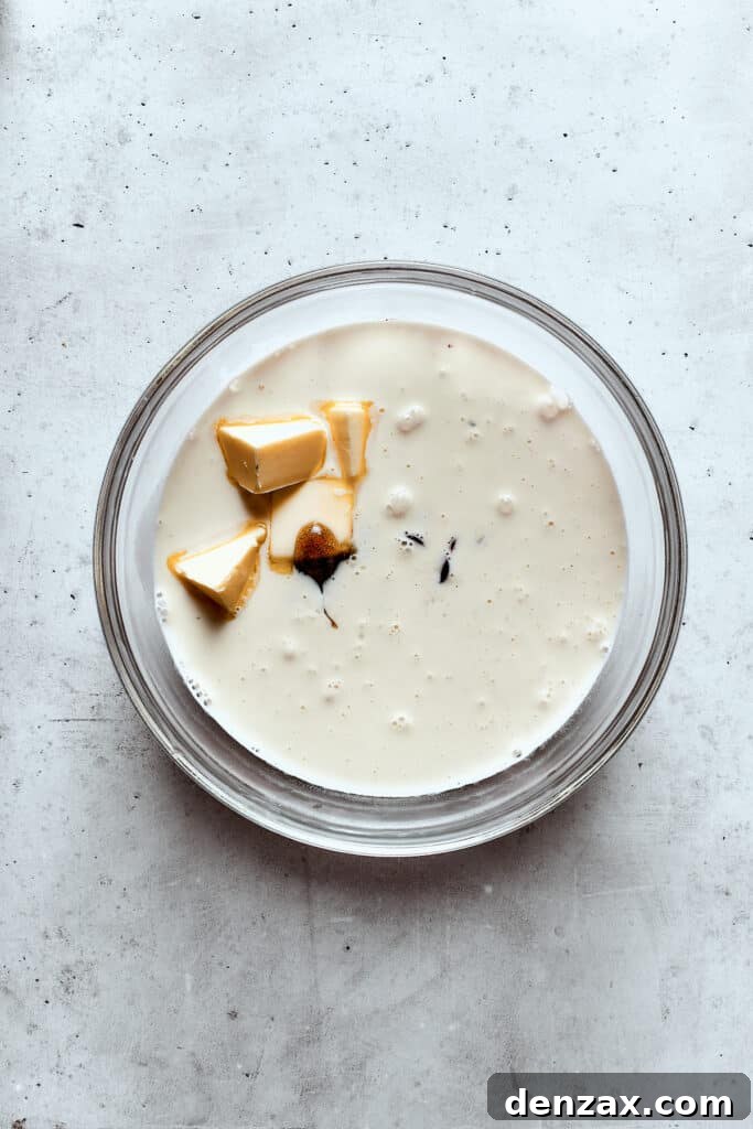 Adding butter to warm cream and chocolate.