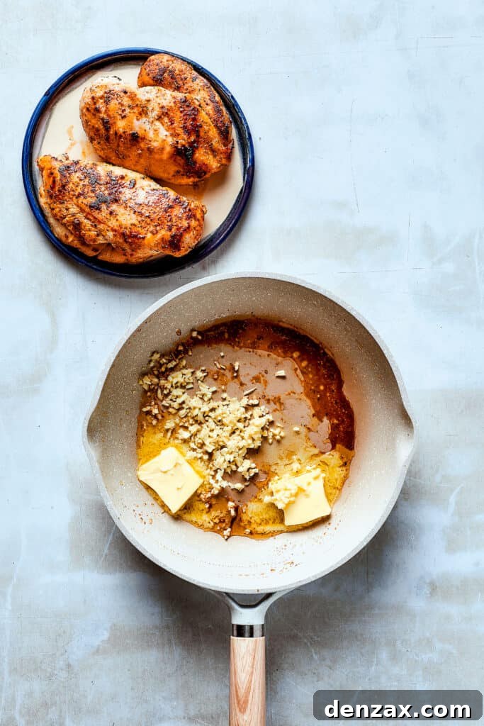 Melted butter and minced garlic simmering in a skillet, creating an aromatic base for the sauce.