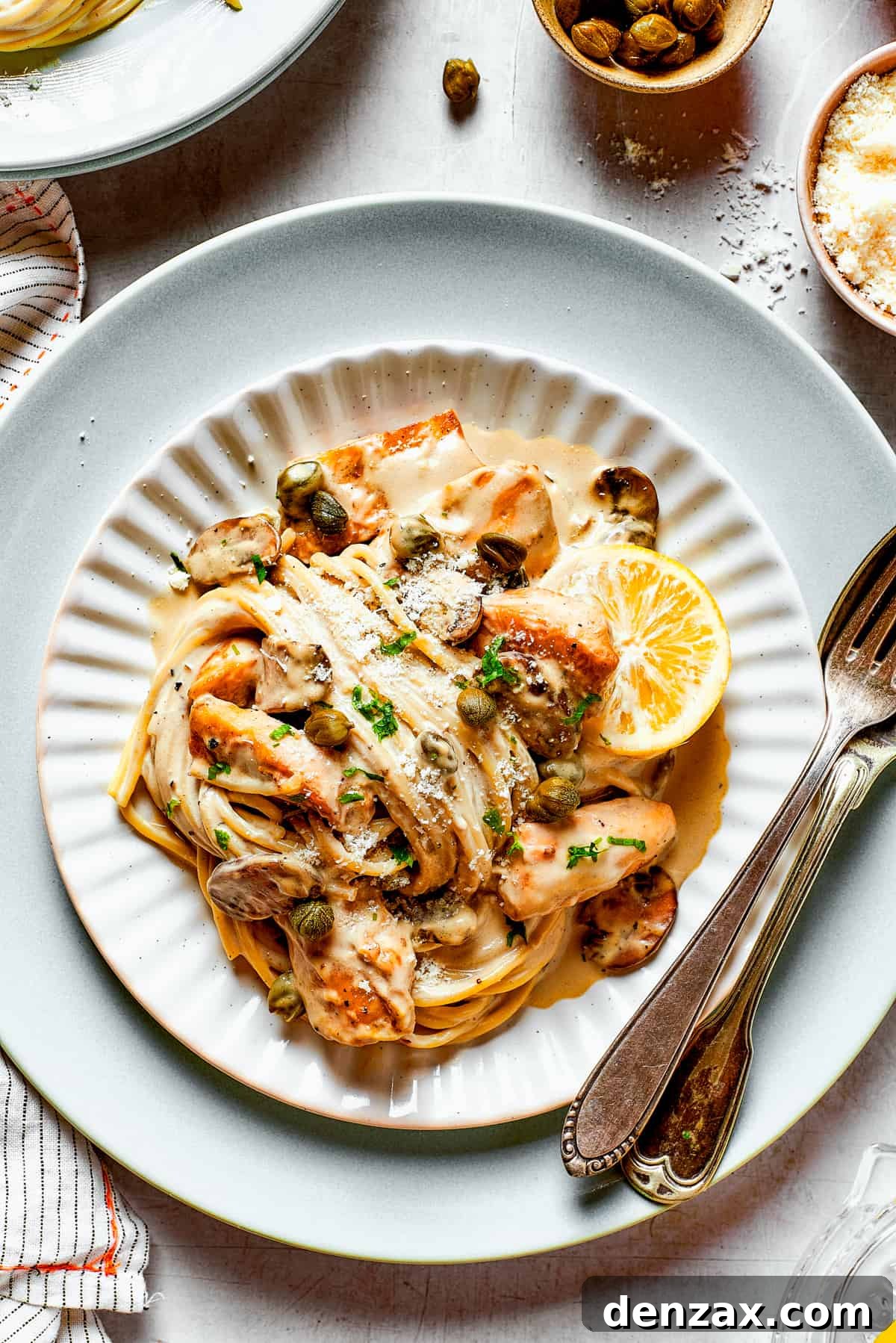 Swirls of pasta in piccata sauce with chicken.