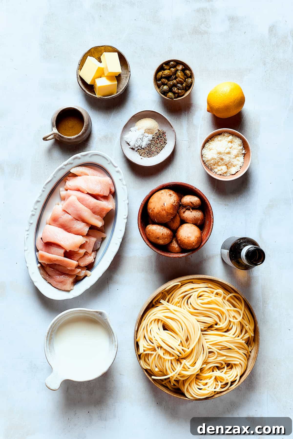 Ingredients for a chicken piccata cheesecake factory copycat, arranged on a work surface.