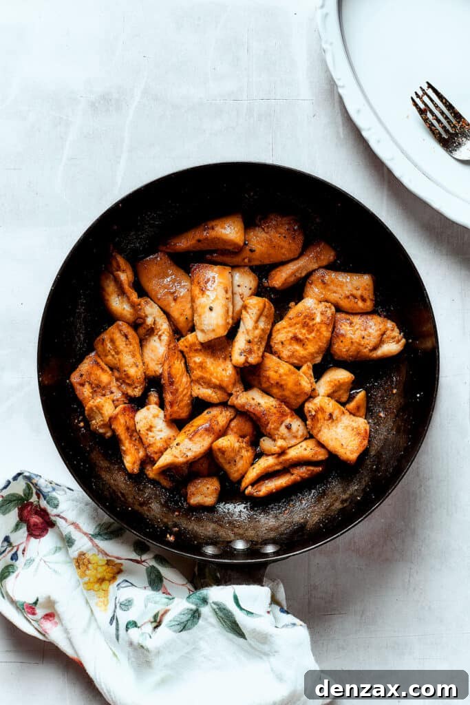 Chicken browning in a skillet.