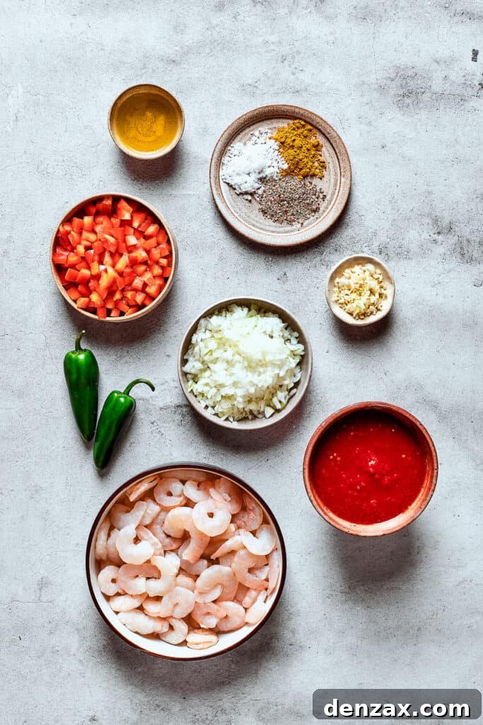 Ingredients for shrimp enchilada filling measured and arranged on a work surface, including diced vegetables, shrimp, and tomato sauce.