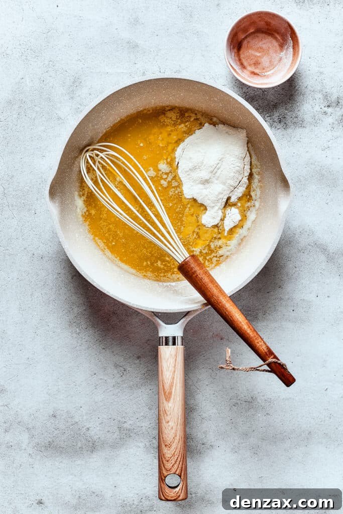 Close-up of butter and flour being cooked in a skillet to make a roux for the sauce.