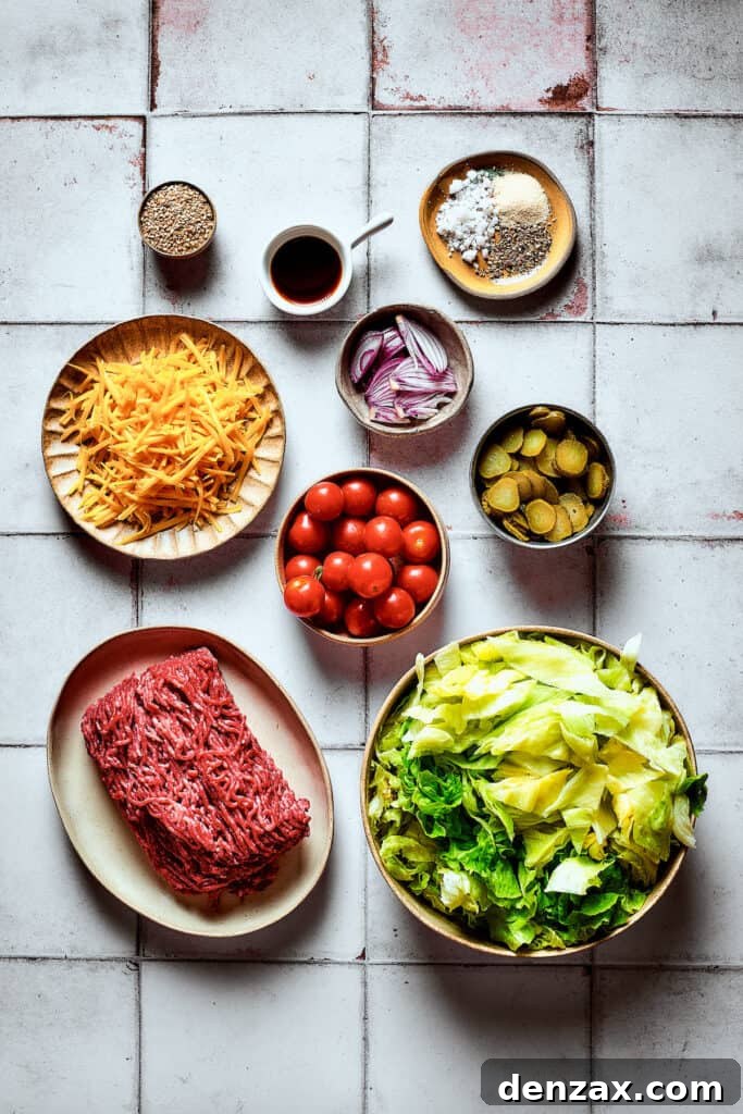 All the fresh ingredients for the Big Mac Salad arranged beautifully on a work surface.