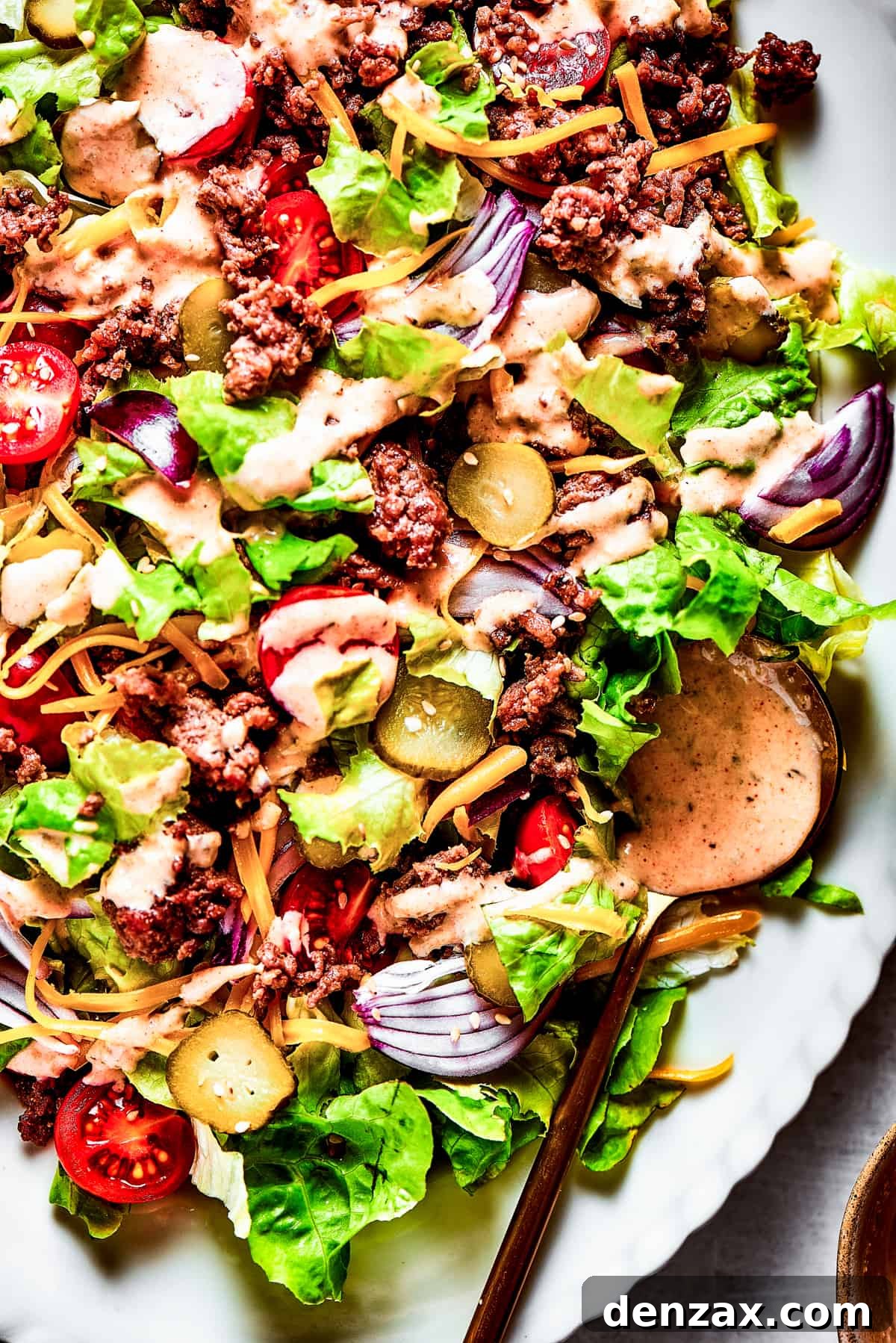 A close-up view of the Big Mac Salad, showing the layered ingredients and the rich dressing.