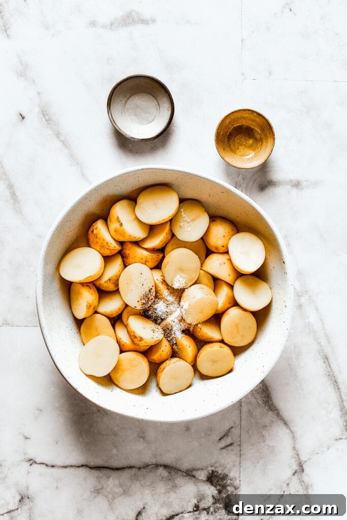 Cut potatoes in a bowl, seasoned with salt, pepper, and olive oil.