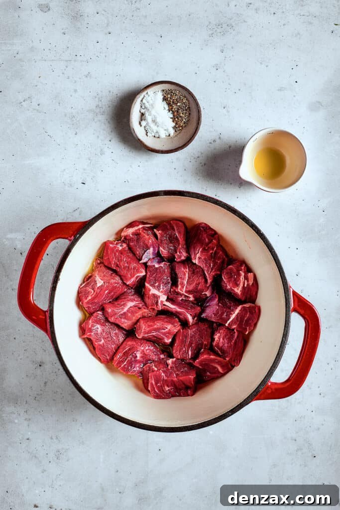 Browning beef in a soup pot, creating a flavorful base for the stew.