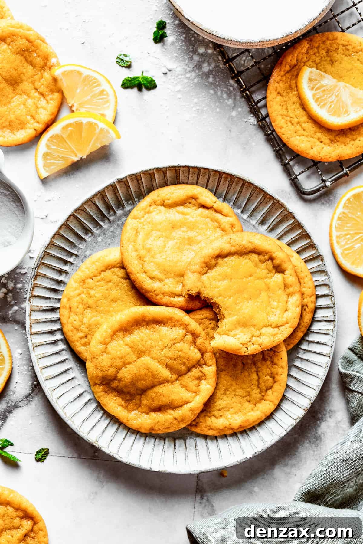 A beautifully arranged plate of freshly baked lemon cookies, ready to be enjoyed, showcasing their vibrant color and inviting texture.