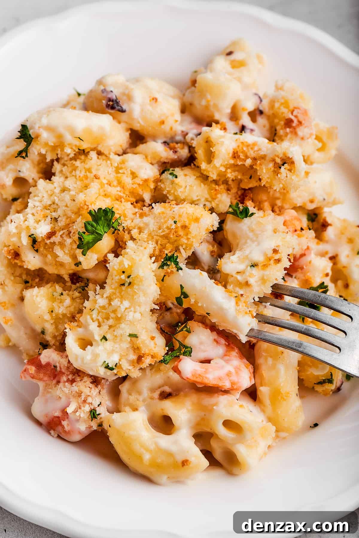 Taking a bite of seafood mac and cheese