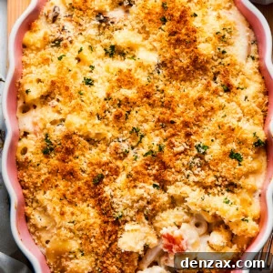 Cooked Seafood mac and cheese with a serving spoon ready to take some out.