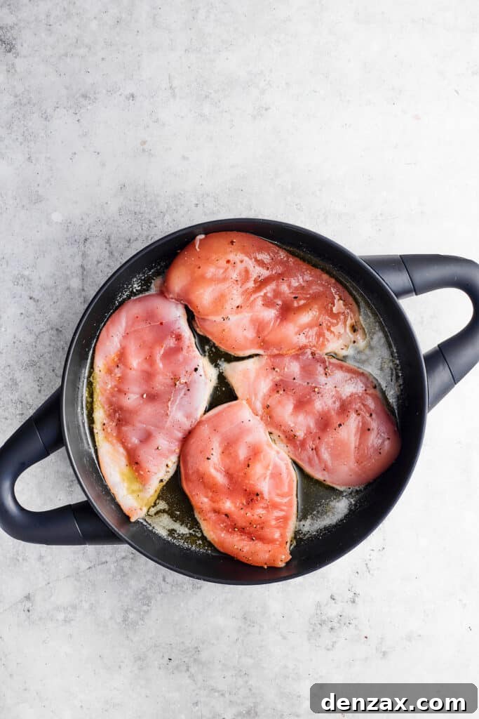 Chicken cutlets are browning beautifully in a skillet with olive oil, developing a golden crust.