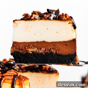 A cake server holding up a slice of turtle cheesecake.