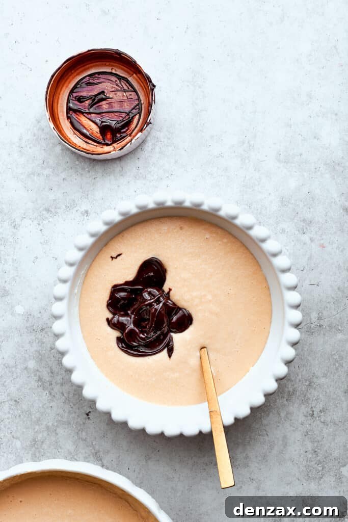 Melted chocolate is stirred into a portion of cheesecake filling, creating a rich chocolate layer.