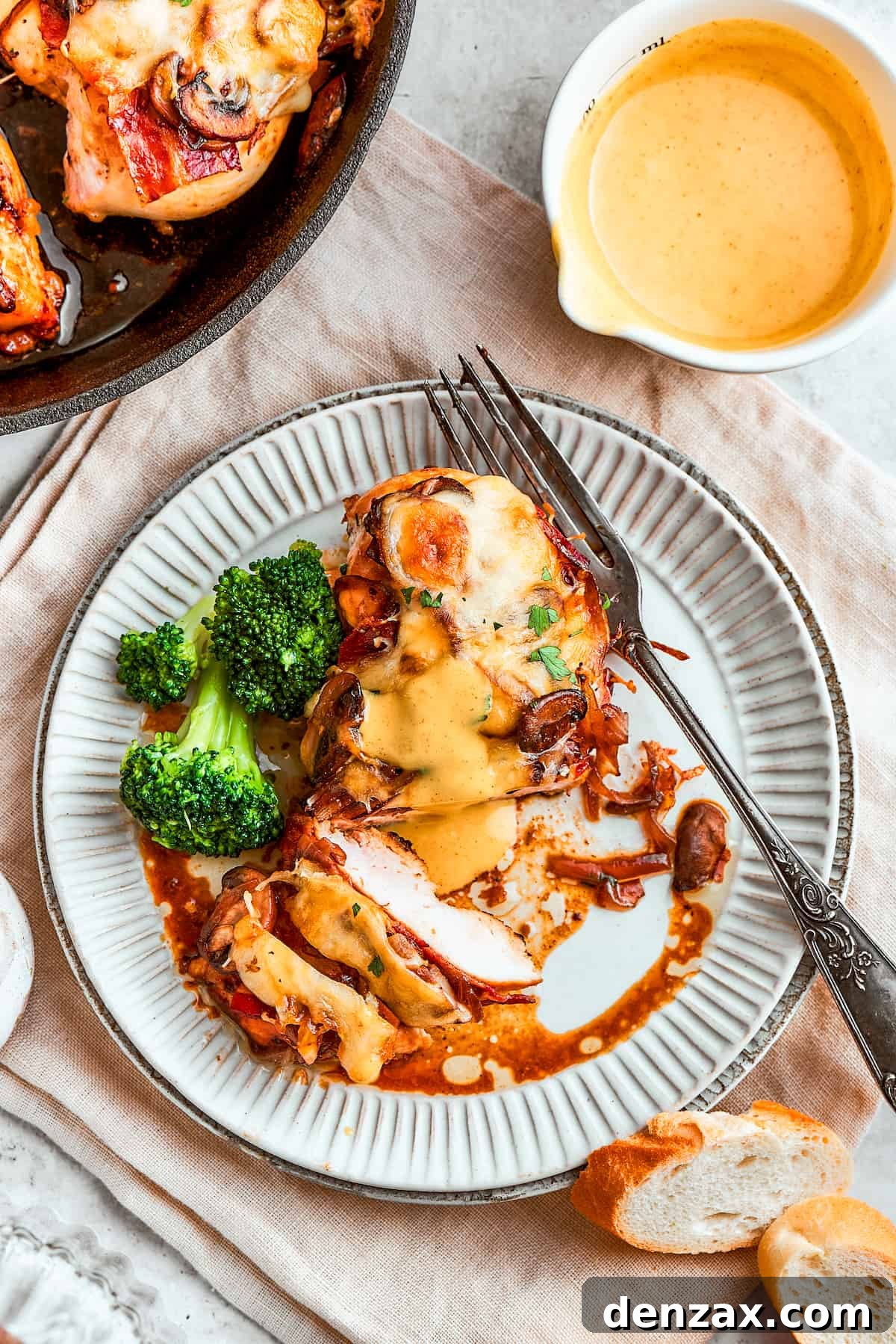 Portions of Alice Springs chicken are shown on plates with a skillet of chicken to the left and a bright pitcher of yellow honey mustard sauce, ready for a delightful meal.