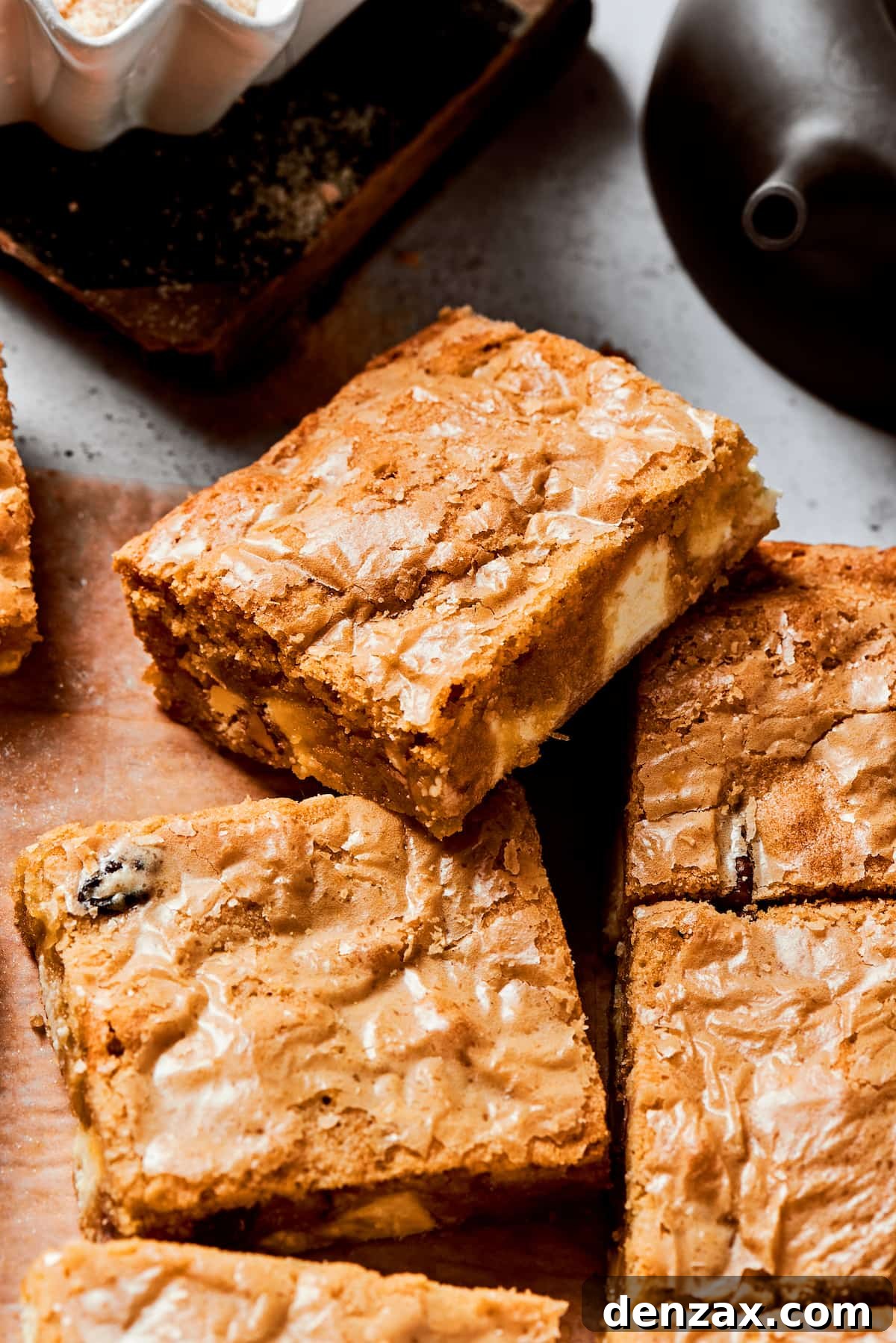 A side view of a blonde brownie on top of more brownies.